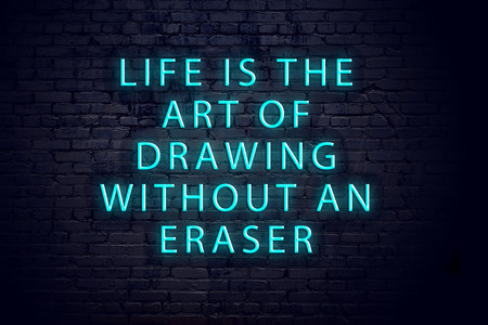 Positive inspiring quote on neon sign against brick wall .の写真素材