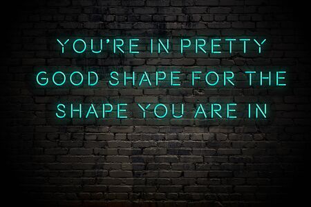 Neon inscription of positive wise motivational quote against brick wall .の写真素材