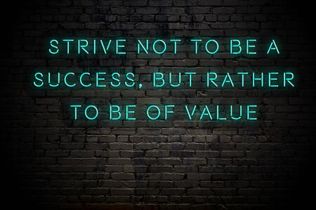 Neon inscription of positive wise motivational quote against brick wall .の写真素材