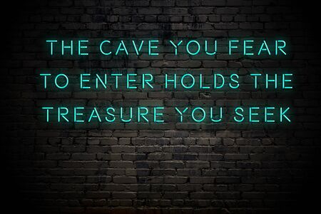 Neon inscription of positive wise motivational quote against brick wall .の写真素材