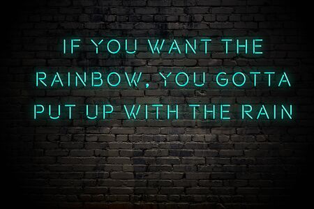 Neon inscription of positive wise motivational quote against brick wall .の写真素材
