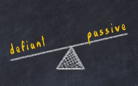 Chalk board sketch of scales. Concept of balance between passive and defiantの写真素材