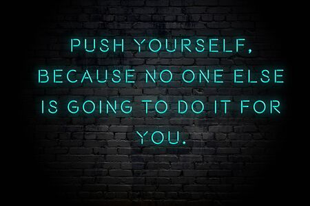 Neon inscription of positive wise motivational quote against brick wall .の写真素材