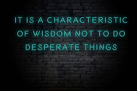 Neon inscription of positive wise motivational quote against brick wall .の写真素材