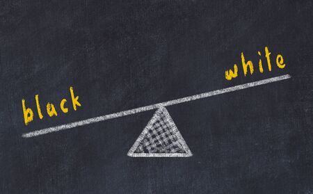 Chalk board sketch of scales. Concept of balance between black and whiteの写真素材