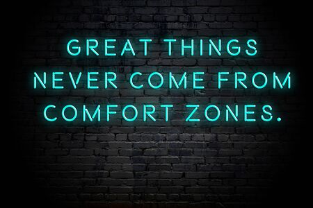 Neon inscription of positive wise motivational quote against brick wall .の写真素材