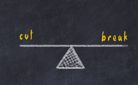 Chalk board sketch of scales. Concept of balance between cut and break.の写真素材