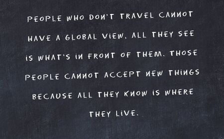 Black chalkboard with handwritten wise motivational quote .の写真素材