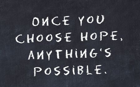 Black chalkboard with handwritten wise motivational quote .の写真素材
