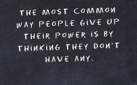 Black chalkboard with handwritten wise motivational quote .の写真素材