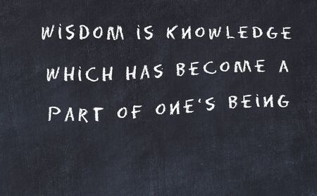 Black chalkboard with handwritten wise motivational quote .の写真素材