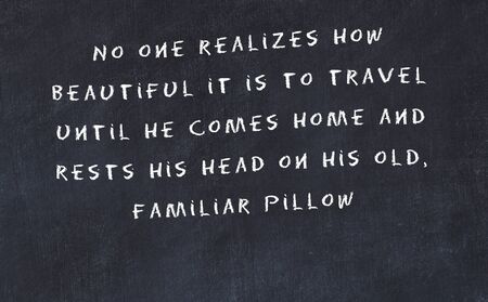 Black chalkboard with handwritten wise motivational quote .の写真素材