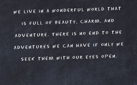 Black chalkboard with handwritten wise motivational quote .の写真素材