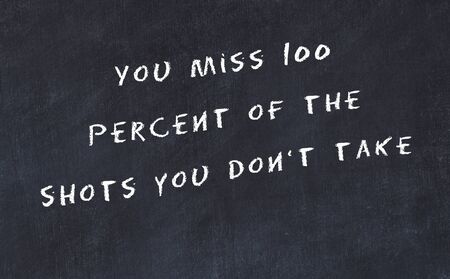 Black chalkboard with handwritten wise motivational quote .の写真素材
