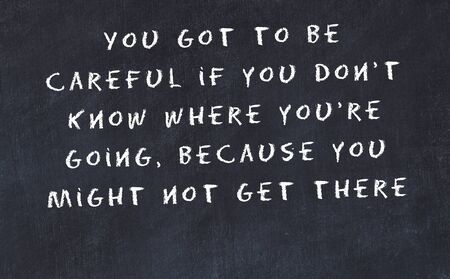Black chalkboard with handwritten wise motivational quote .の写真素材