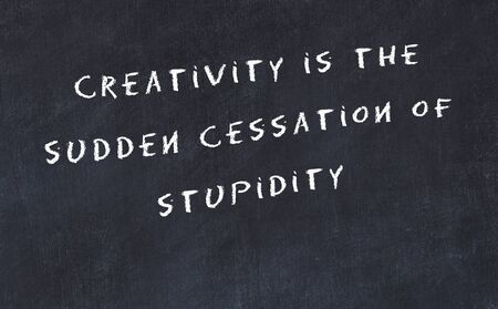 Black chalkboard with handwritten wise motivational quote .の写真素材