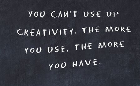 Black chalkboard with handwritten wise motivational quote .の写真素材