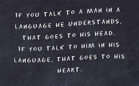 Black chalkboard with handwritten wise motivational quote .の写真素材