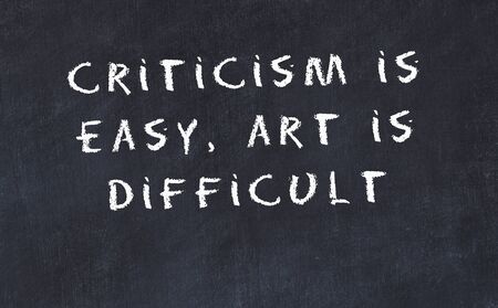 Black chalkboard with handwritten wise motivational quote .の写真素材