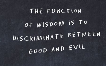 Black chalkboard with handwritten wise motivational quote .の写真素材