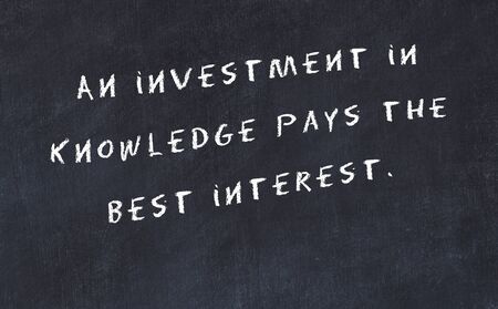 Black chalkboard with handwritten wise motivational quote .の写真素材