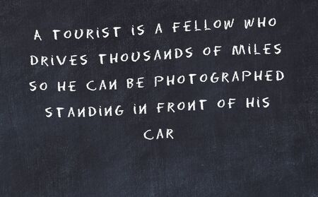 Black chalkboard with handwritten wise motivational quote .の写真素材