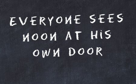 Black chalkboard with handwritten wise motivational quote .の写真素材