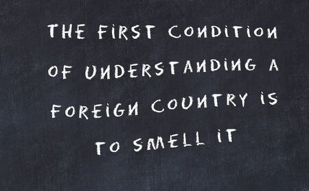 Black chalkboard with handwritten wise motivational quote .の写真素材