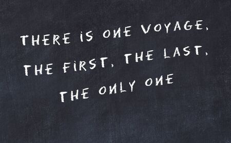 Black chalkboard with handwritten wise motivational quote .の写真素材
