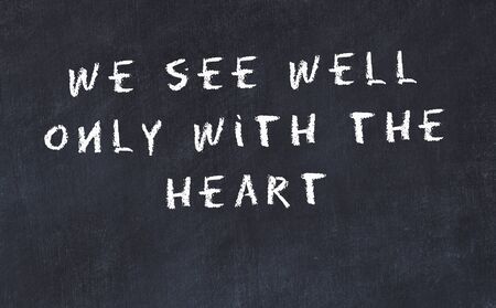 Black chalkboard with handwritten wise motivational quote .の写真素材