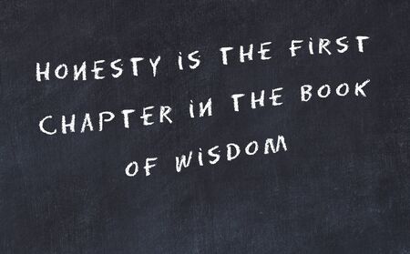 Black chalkboard with handwritten wise motivational quote .の写真素材