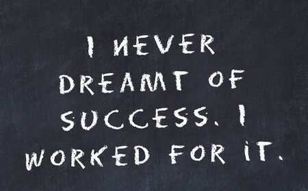Black chalkboard with handwritten wise motivational quote .の写真素材