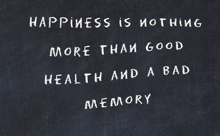 Black chalkboard with handwritten wise motivational quote .の写真素材