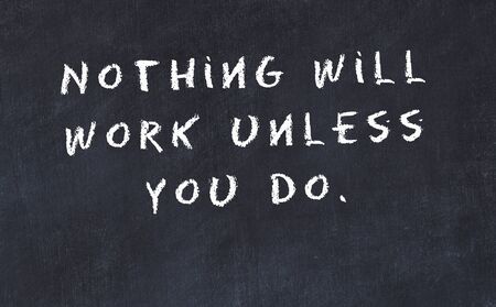 Black chalkboard with handwritten wise motivational quote .の写真素材