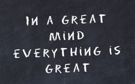 Black chalkboard with handwritten wise motivational quote .の写真素材