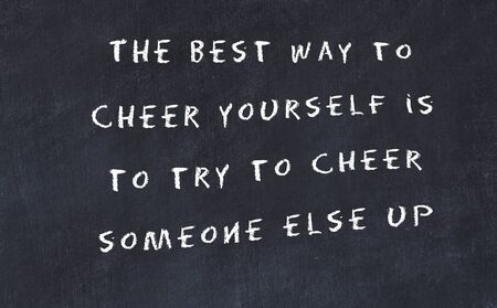 Black chalkboard with handwritten wise motivational quote .の写真素材