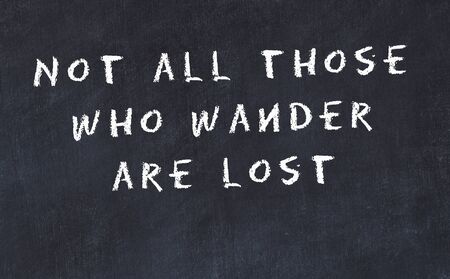 Black chalkboard with handwritten wise motivational quote .の写真素材