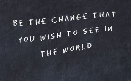 Black chalkboard with handwritten wise motivational quote .の写真素材