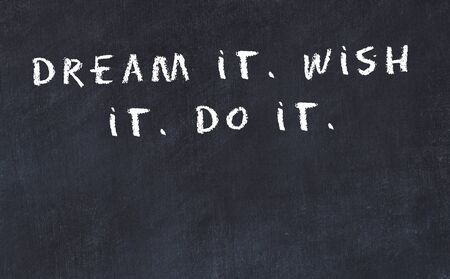 Black chalkboard with handwritten wise motivational quote .の写真素材