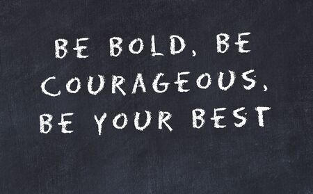 Black chalkboard with handwritten wise motivational quote .の写真素材