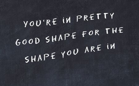 Black chalkboard with handwritten wise motivational quote .の写真素材