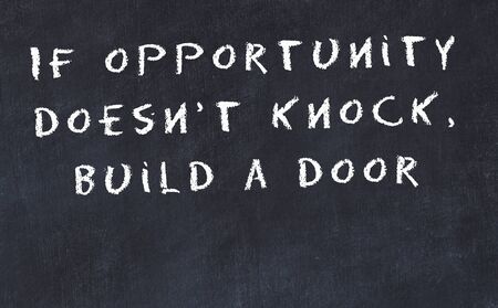 Black chalkboard with handwritten wise motivational quote .の写真素材