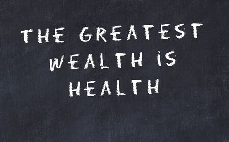 Black chalkboard with handwritten wise motivational quote .の写真素材