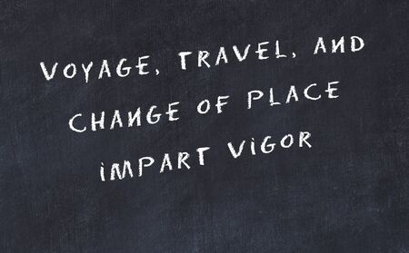 Black chalkboard with handwritten wise motivational quote .の写真素材