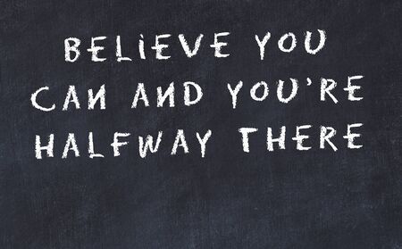Black chalkboard with handwritten wise motivational quote .の写真素材
