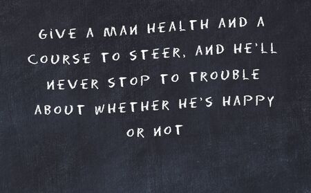 Black chalkboard with handwritten wise motivational quote .の写真素材