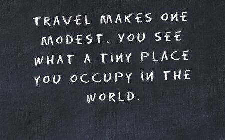 Black chalkboard with handwritten wise motivational quote .の写真素材