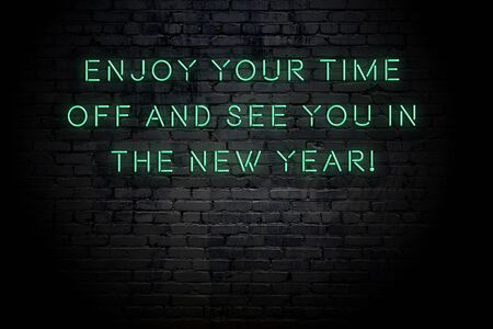 Neon inscription of christmas and new year greetings on brick wall.の写真素材