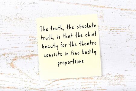 Wise quotation handwritten on yellow sticky note hanging on wooden wallの写真素材