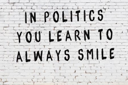 White brick wall and  black painted inscription of  wise quotationの写真素材